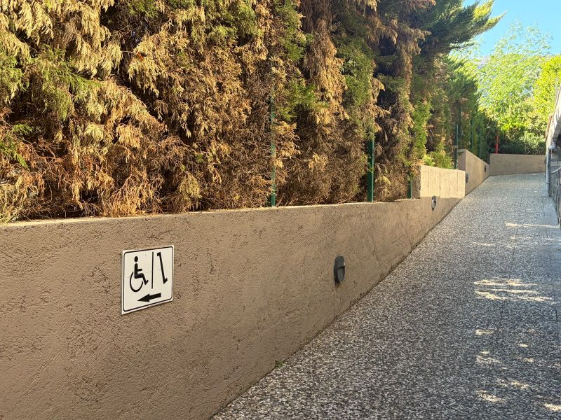 Wheelchair ramp with directional sign